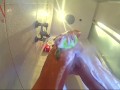 Voyeur camera in the shower. A nude girl in the shower is washed with soap.
