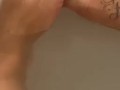 Wet ebony feet in bath tub