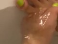 Wet ebony feet in bath tub
