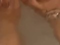 Wet ebony feet in bath tub