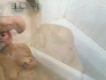 A mature bitch takes a shower and sucks a dick, rubbing sperm on big tits))