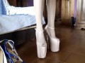 Laura is wearing miniskirt, stockings and 8 inches high heels