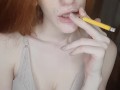 redhead girl smokes a cigarette