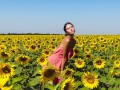 Fertility goddess caresses her pussy in a sunflower field
