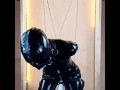 Latex doll in bondage gagged and blindfolded