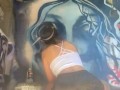 Girl with nice ass in booty shorts does graffiti
