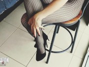 Shoe dangling with fishnets and black high heels