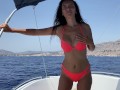 Brunette with big tits masturbates in the open sea on a boat