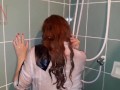A chick in clothes under the shower. Wet panties, wet trousers, wet shirt. Full