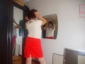 A naked lady does make-up in front of a mirror, puts on underwear, stockings, a skirt. 3