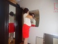 A naked lady does make-up in front of a mirror, puts on underwear, stockings, a skirt. 3