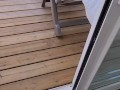 Amateur milf plays with her pussy on a public balcony