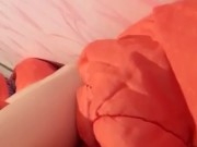 Masturbation squeezing a blanket between legs