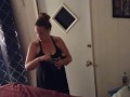 Pretty girl smoking in her night dress while watching tv