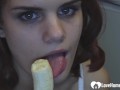 Brunette babe show's her sucking skills on banana