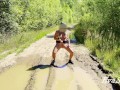sexy blonde pissing in a puddle on the road