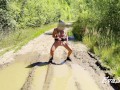 sexy blonde pissing in a puddle on the road