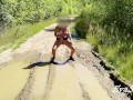 sexy blonde pissing in a puddle on the road