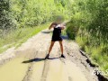 sexy blonde pissing in a puddle on the road