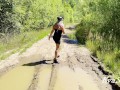 sexy blonde pissing in a puddle on the road
