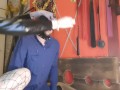 Sperm games. The dominatrix brings used condoms and pours the contents over her slave's head.