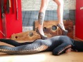 Trampling the body of a slave in shoes with pointed heels