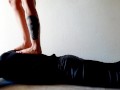 Trampling. Dominatrix Nika walks on the back of her slave with bare feet