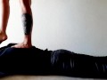 Trampling. Dominatrix Nika walks on the back of her slave with bare feet