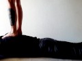 Trampling. Dominatrix Nika walks on the back of her slave with bare feet