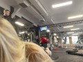Naughty girl flashing tits in gym right next to the men’s company. Public.