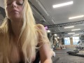 Naughty girl flashing tits in gym right next to the men’s company. Public.