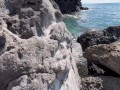 Gorgeous readhed fucked on the beach between the rocks