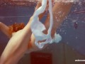 In the indoor pool, a stunning girl swims