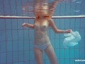 In the indoor pool, a stunning girl swims