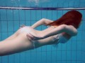 Diana's redhead beauty enhances her swimming grace