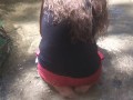 Cute long hair girl on her knees looking for shells to collect in popular spring creek