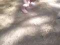 Cute long hair girl on her knees looking for shells to collect in popular spring creek