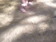 Cute long hair girl on her knees looking for shells to collect in popular spring creek