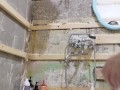 slender student washes in a dirty shower