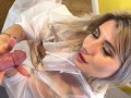 College girl gives a handjob with balls massage and playing teasing the big cock in a raincoat under an umbrella