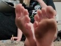 Hot blonde chilling on the floor showing off her dirty stained soles while she smokes a cigarette