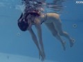 Very small teen in red swimming and posing