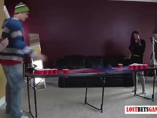 Three girls and one guy play a game of strip  pong