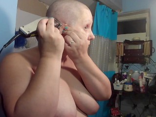 Topless bald girl shaving head