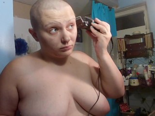 Topless bald girl shaving head