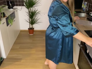 Sexy mother-in-law in a silk robe pees in the kitchen for her son-in-law