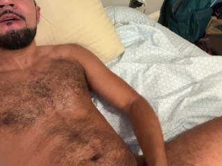 Hairy guy jerking off in bed quickly cums on himself