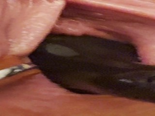 Birthing inflatable plug from spread out pussy - closeup