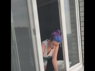 A neighbor girl washes windows without a bra and panties