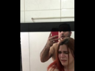 Having sex with my girl in a public bathroom, recording while I do it.